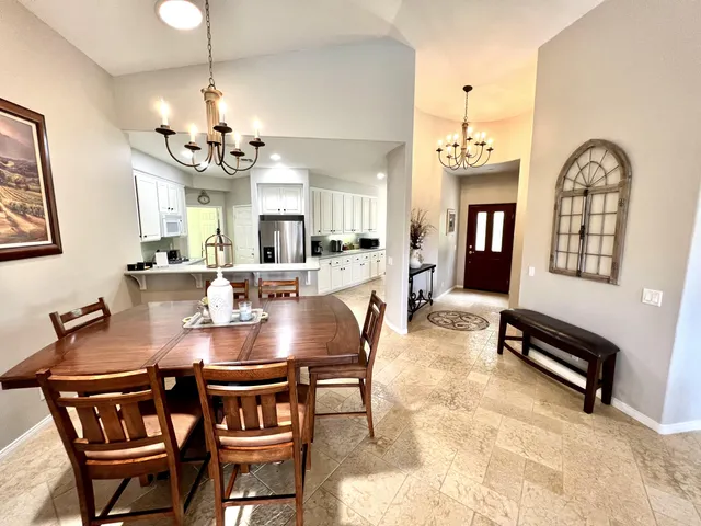 a view of a dining room with furniture and chandelier