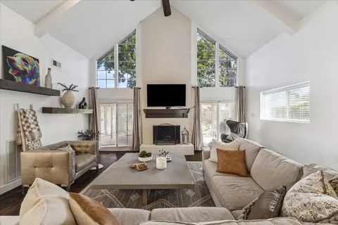 a living room with fireplace furniture and a wooden floor