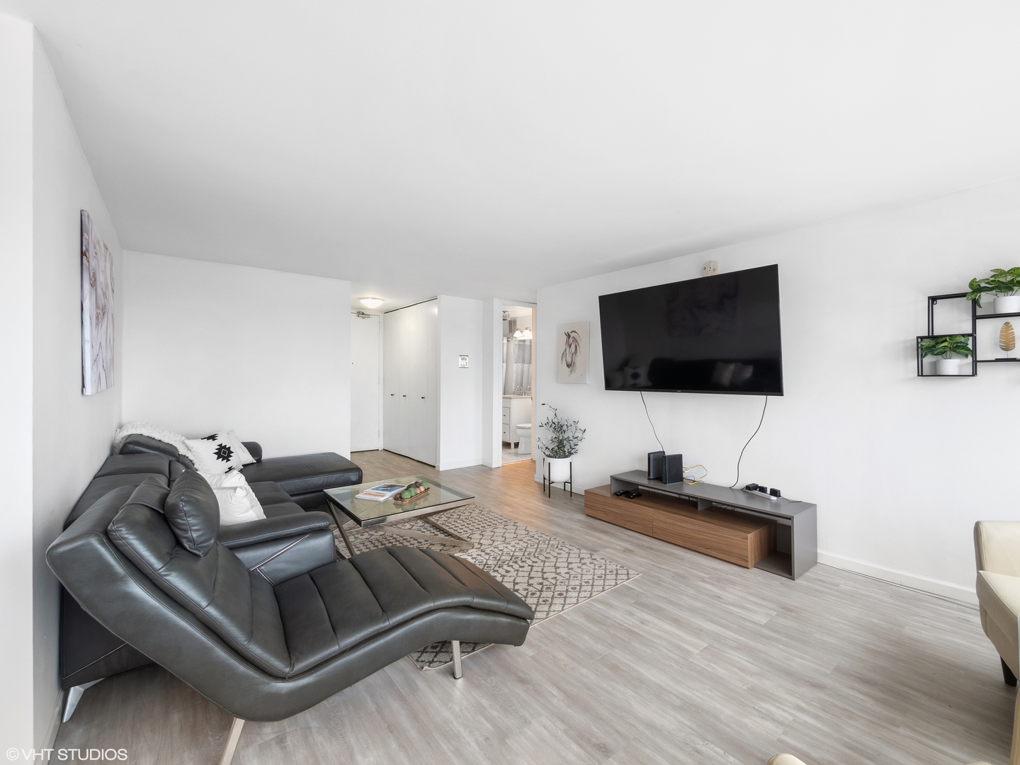 655 West Irving Park Road, Unit 2303 Chicago, IL 60613 - Photo 3 of 13 a living room with furniture and a flat screen tv