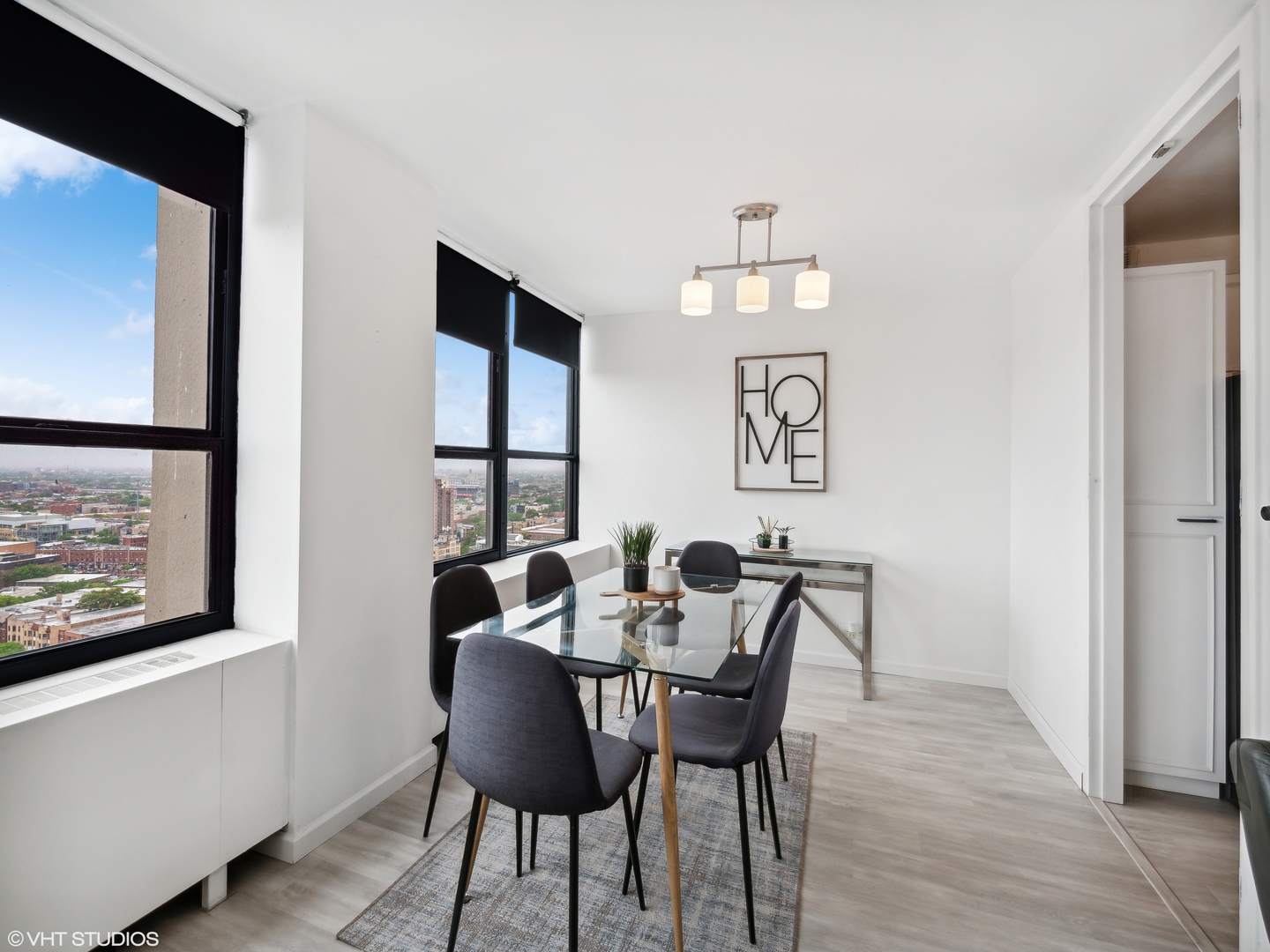 655 West Irving Park Road, Unit 2303 Chicago, IL 60613 - Photo 5 of 13 a view of a dining room with furniture window and wooden floor