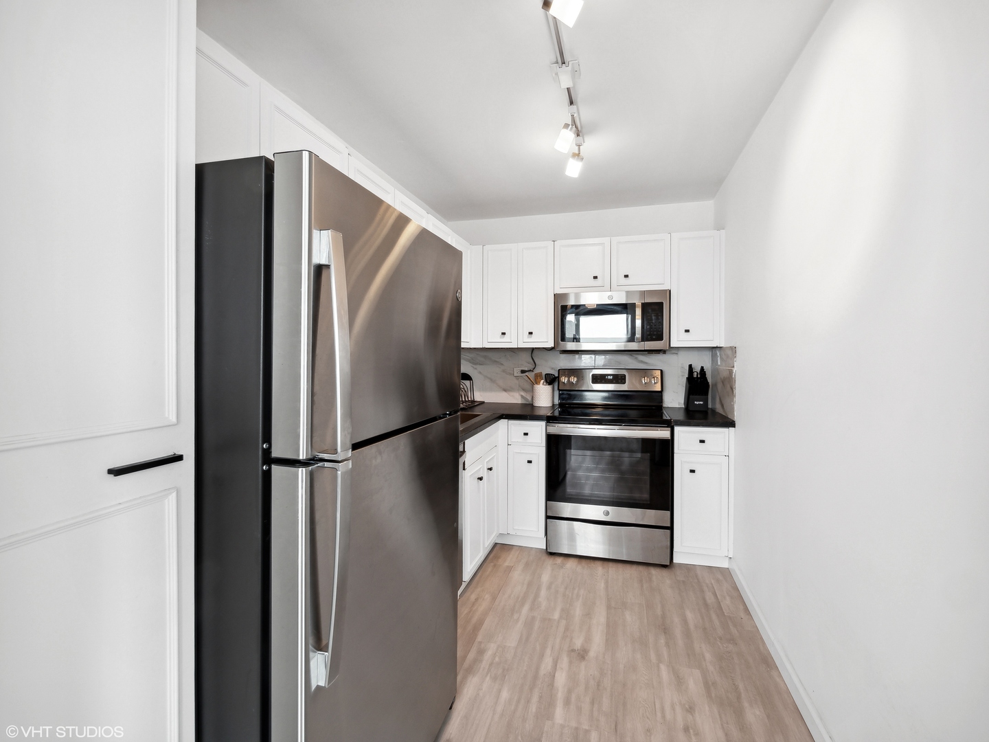 655 West Irving Park Road, Unit 2303 Chicago, IL 60613 - Photo 6 of 13 a kitchen with a refrigerator and a stove top oven
