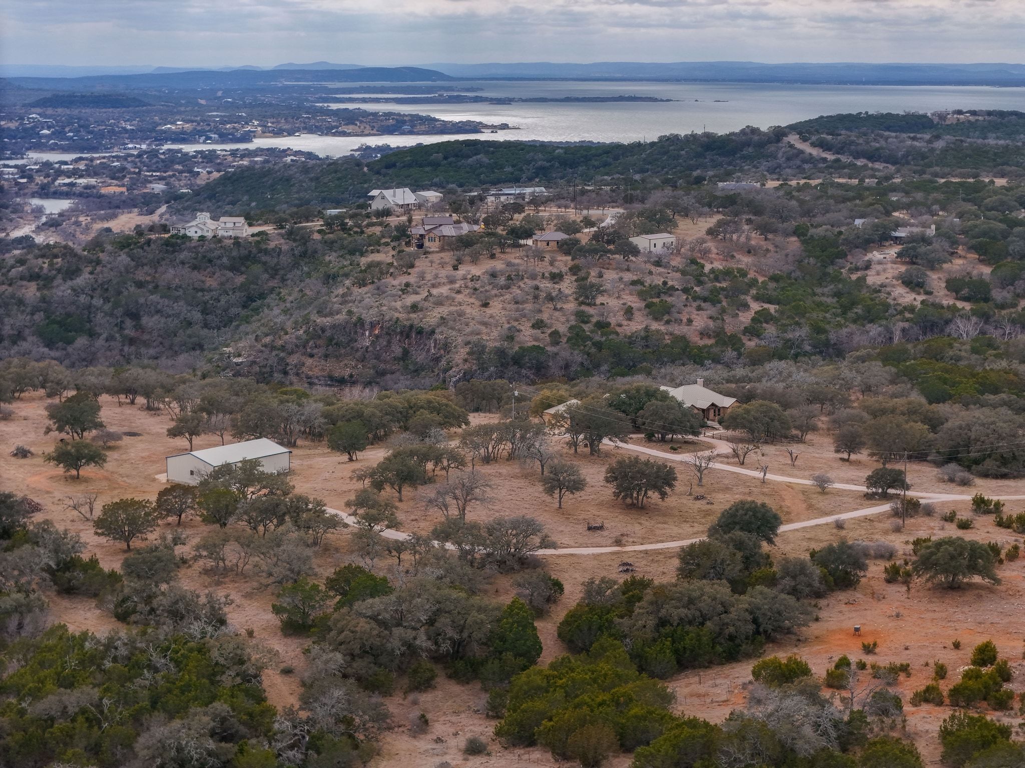 2551 Wolf Creek Ranch Road Burnet, TX 78611 - Photo 37 of 40 Aerial view of property and surrounding area featuring rural landscape and a large body of water