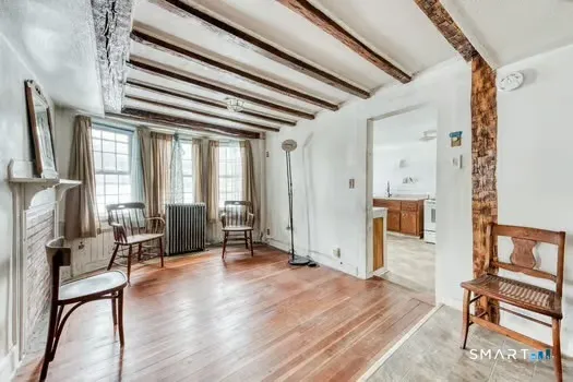 a view of a livingroom with furniture and a window