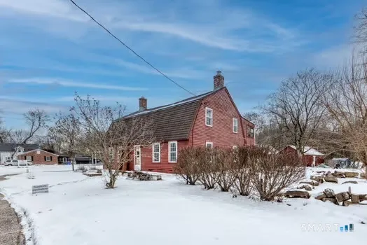 a view of a house with a snow in the yard