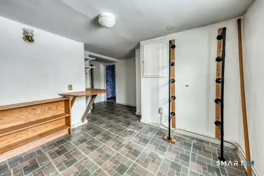 a view of a hallway with wooden floor and entryway