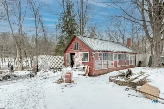 a view of a house with a yard covered in snow