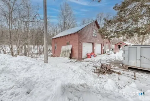 a view of a house with a yard covered in snow