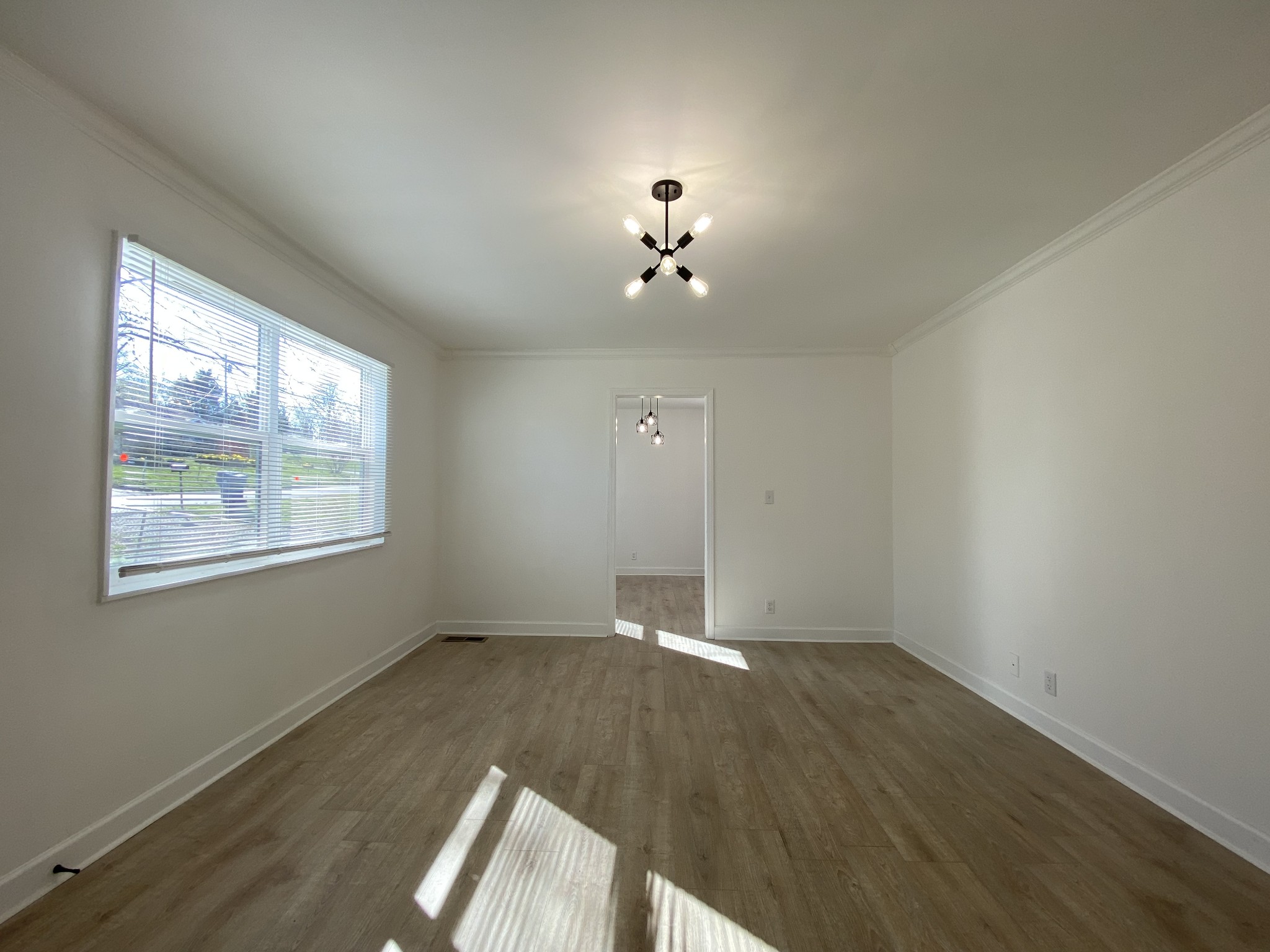 245 Raintree Drive Clarksville, TN 37042 - Photo 13 of 33 an empty room with wooden floor and windows