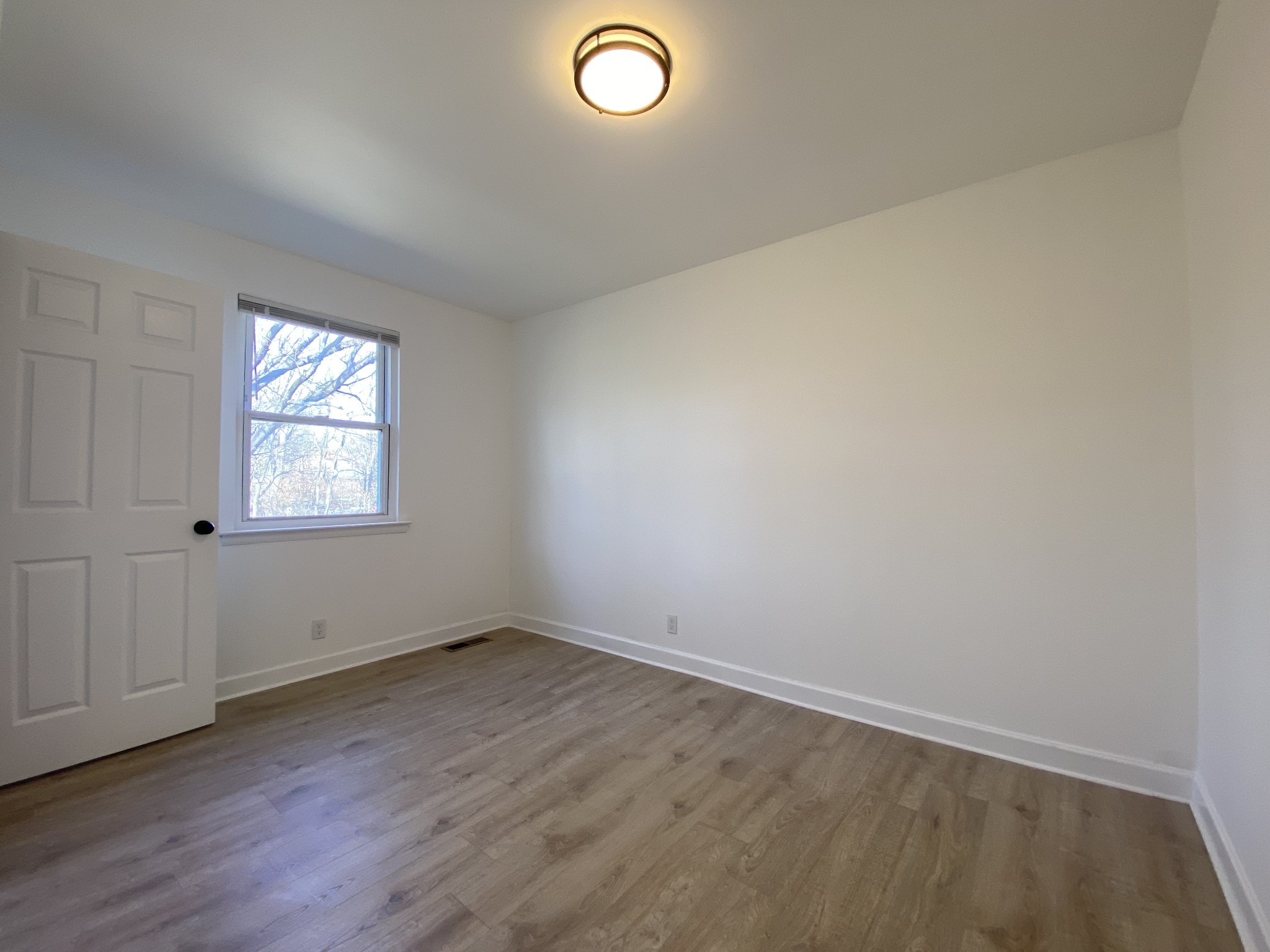 245 Raintree Drive Clarksville, TN 37042 - Photo 16 of 33 an empty room with wooden floor and windows