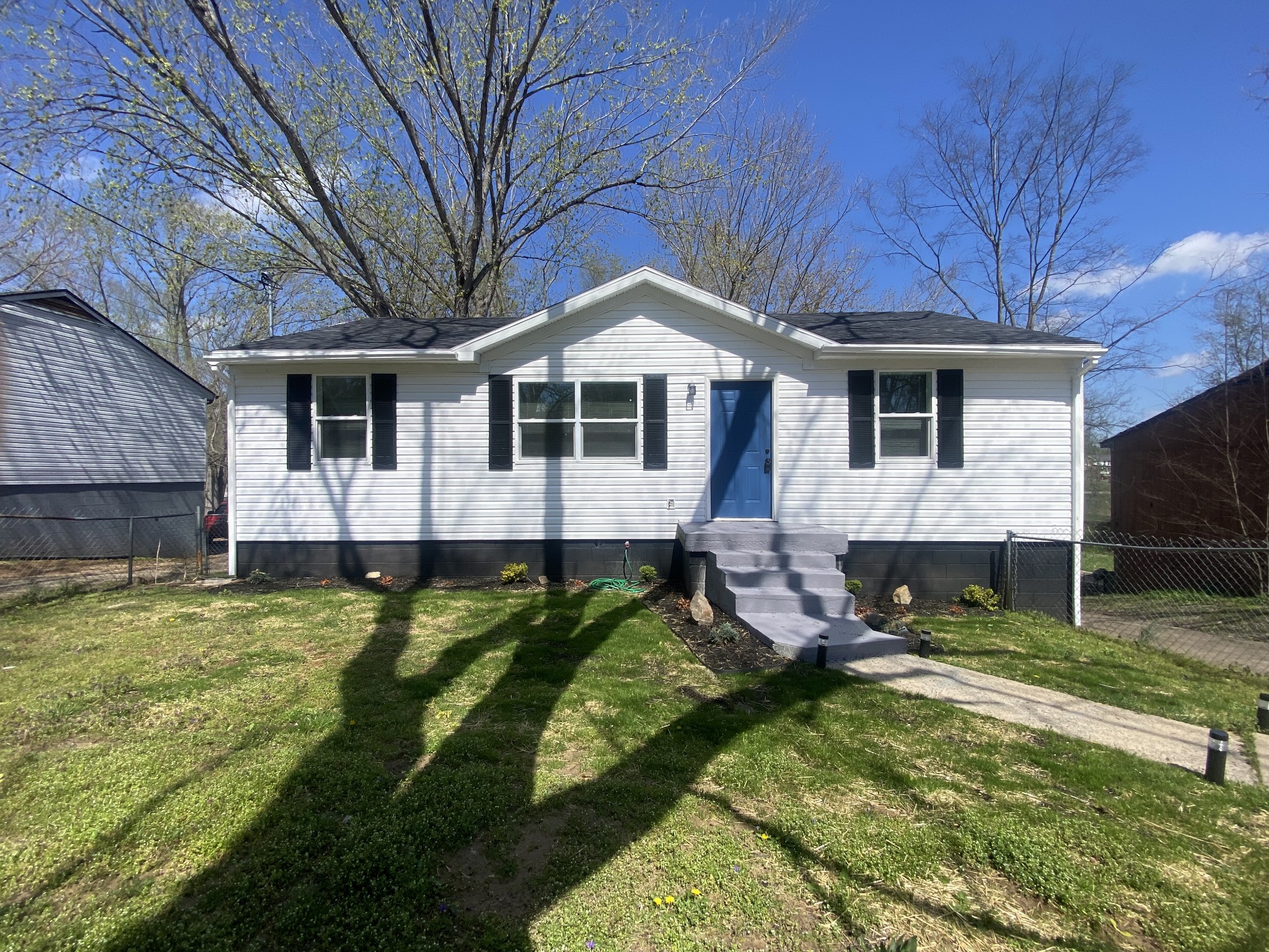 245 Raintree Drive Clarksville, TN 37042 - Photo 2 of 33 a front view of a house with a yard table and chairs