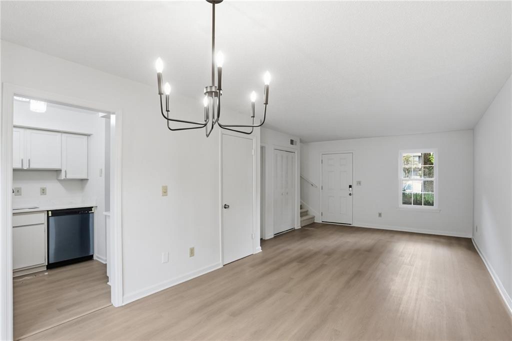 413 Promenade Court Marietta, GA 30064 - Photo 12 of 28 a view of empty room with wooden floor and window