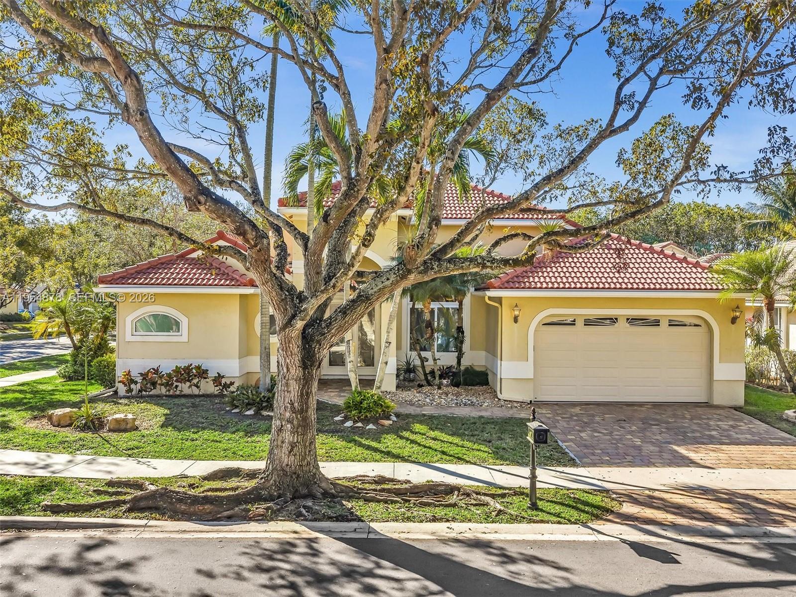 a front view of a house with a yard and garage