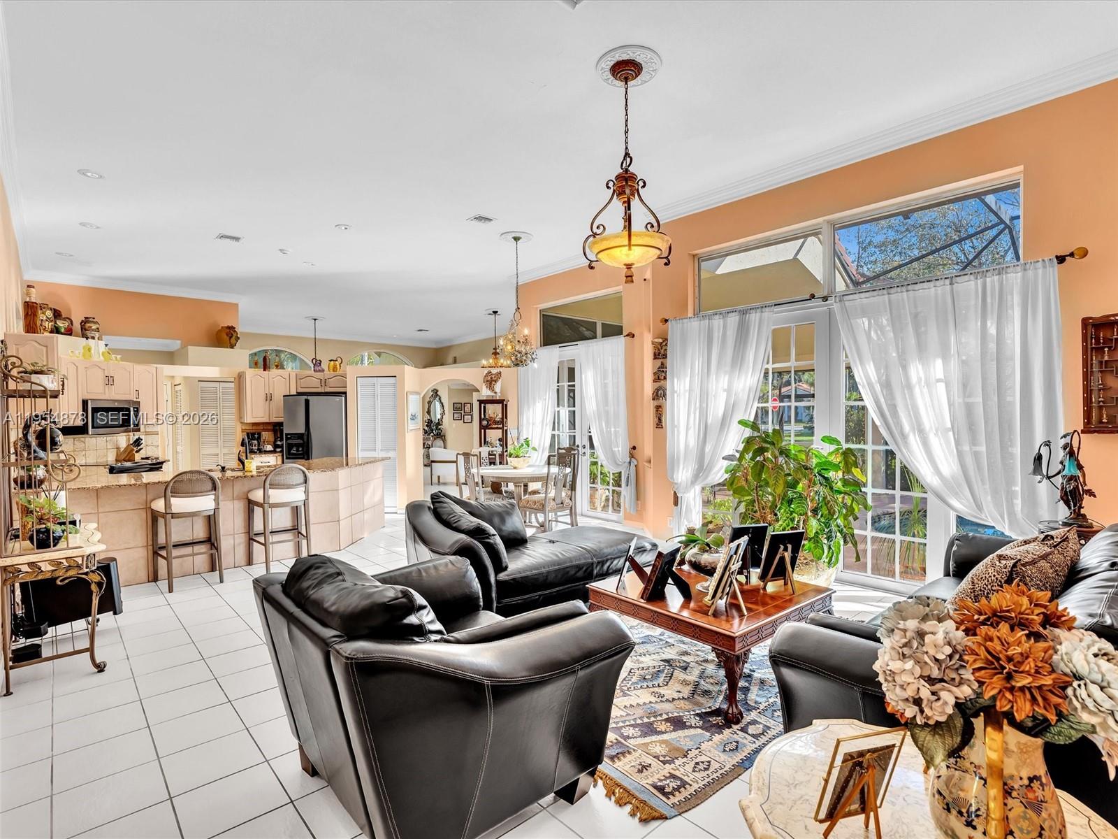 900 Spoonbill Circle Weston, FL 33326 - Photo 12 of 51 a living room with furniture a couch and a chandelier