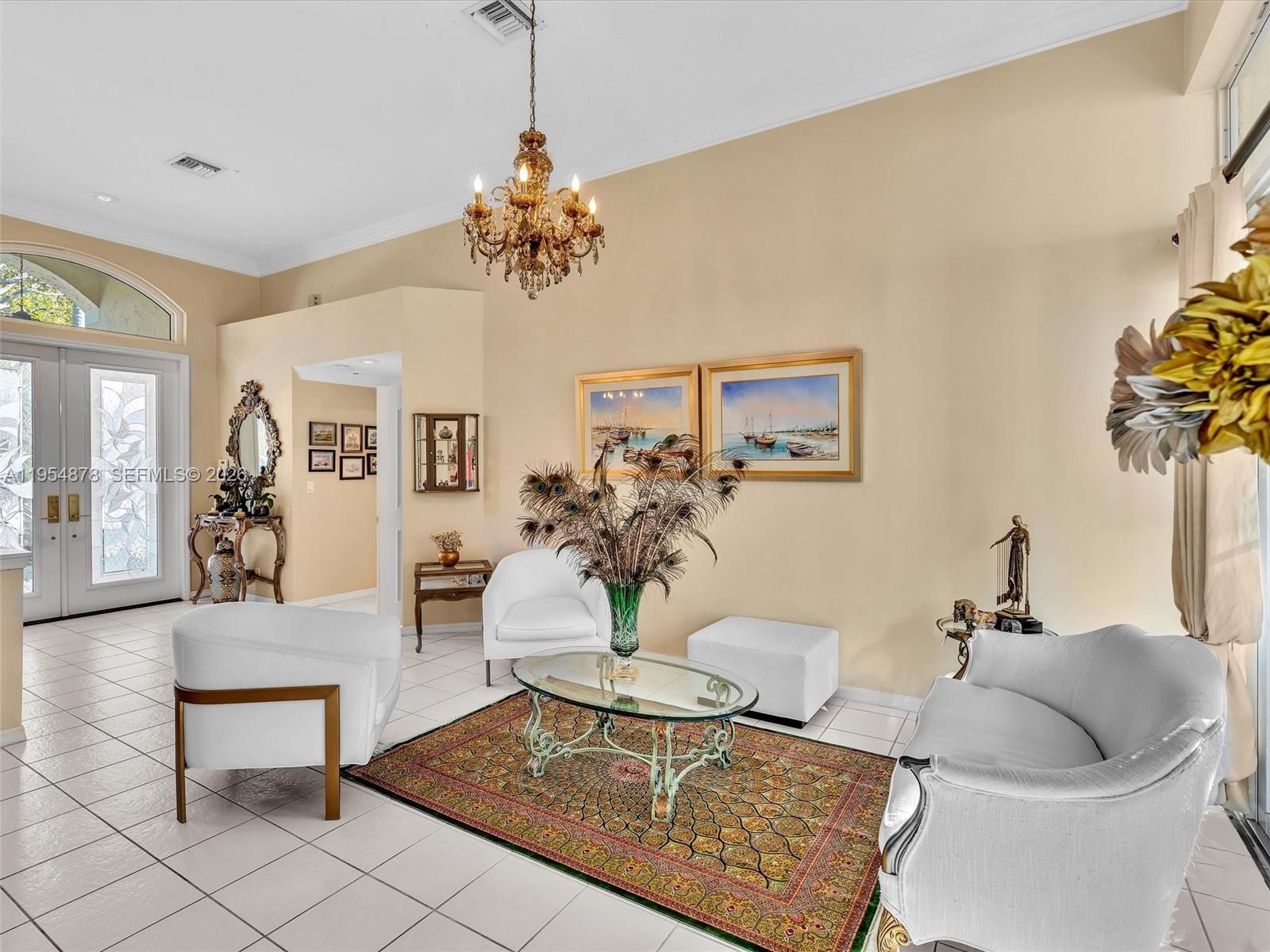 900 Spoonbill Circle Weston, FL 33326 - Photo 13 of 51 a living room with furniture and a chandelier
