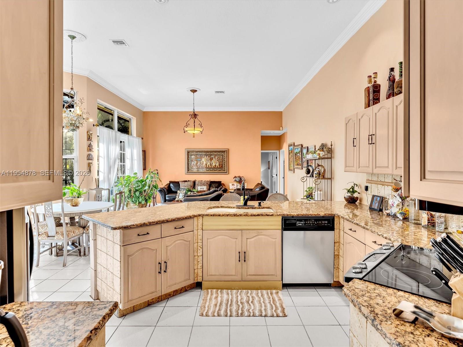 900 Spoonbill Circle Weston, FL 33326 - Photo 16 of 51 a kitchen with stainless steel appliances a sink and cabinets