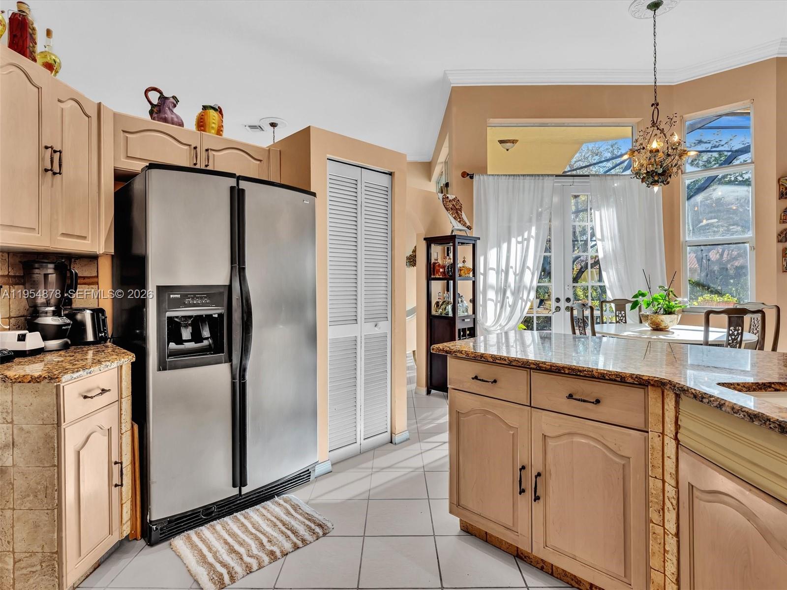 900 Spoonbill Circle Weston, FL 33326 - Photo 18 of 51 a kitchen with stainless steel appliances a refrigerator sink and cabinets