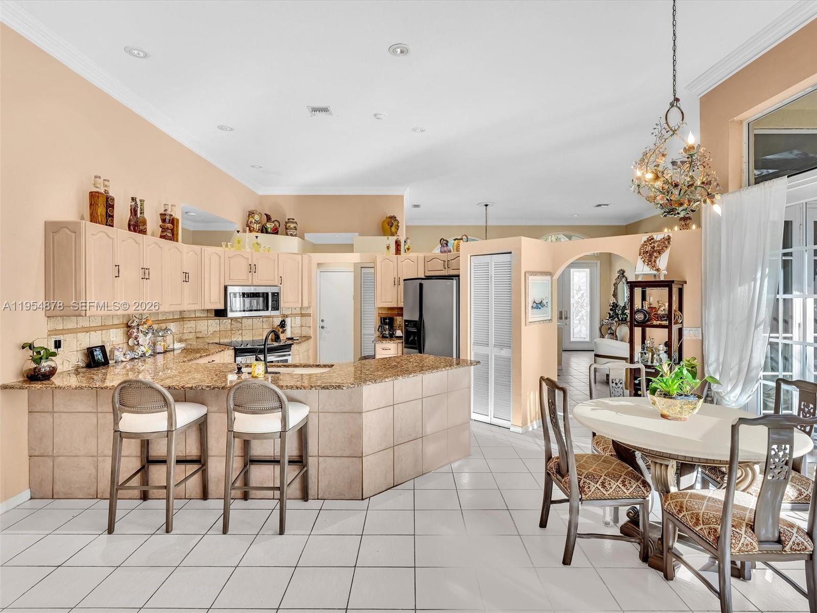 900 Spoonbill Circle Weston, FL 33326 - Photo 19 of 51 a view of a dining room with furniture