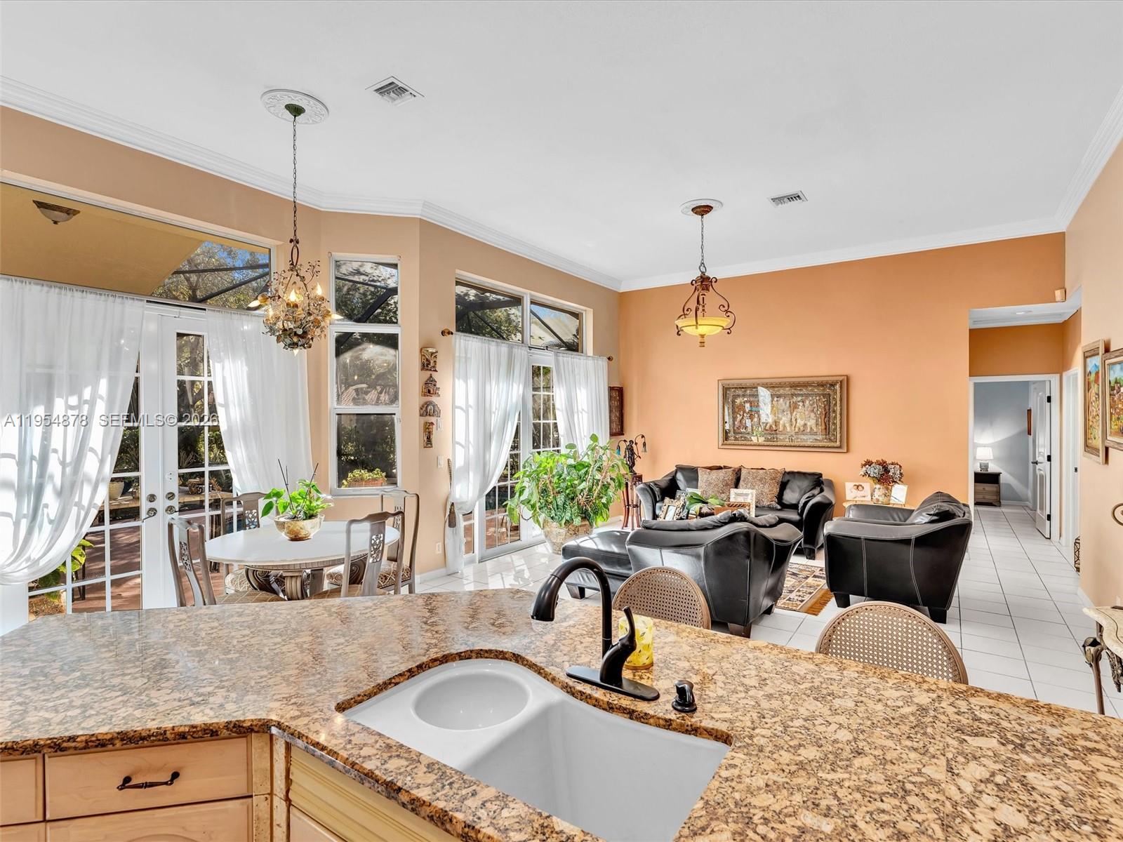 900 Spoonbill Circle Weston, FL 33326 - Photo 21 of 51 a living room with furniture a fireplace and a chandelier