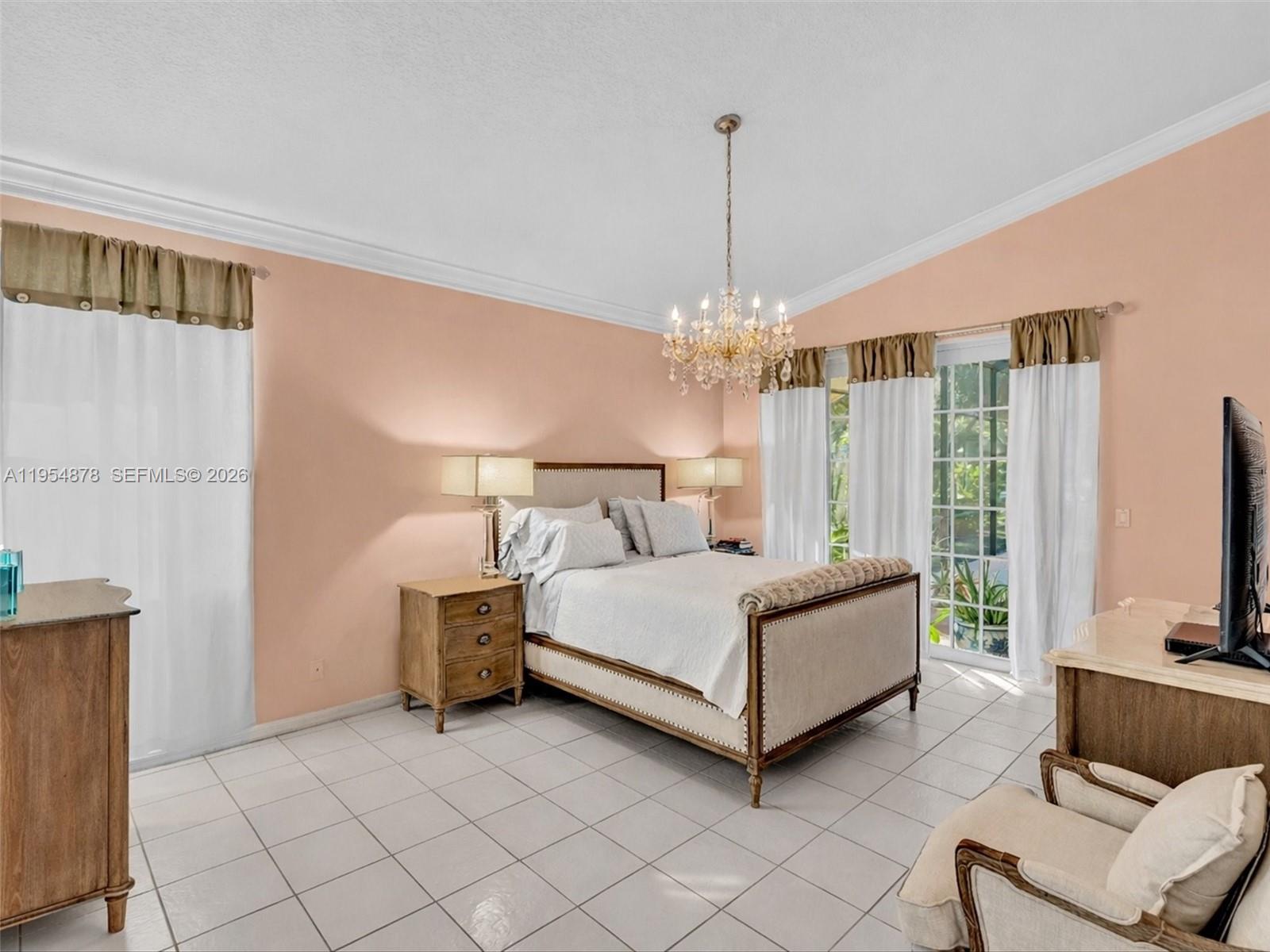 900 Spoonbill Circle Weston, FL 33326 - Photo 22 of 51 a living room with furniture and a chandelier