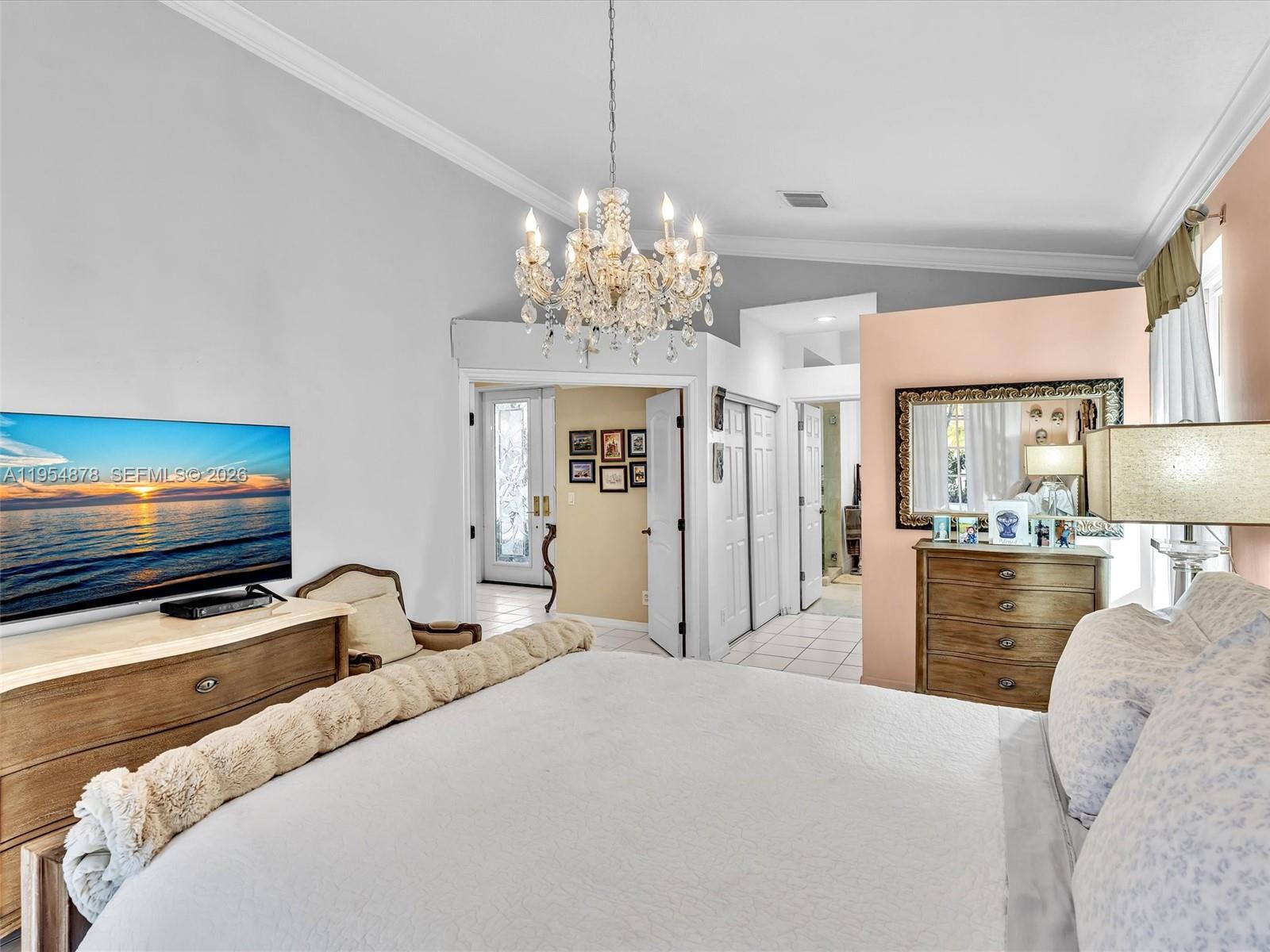 900 Spoonbill Circle Weston, FL 33326 - Photo 24 of 51 a bedroom with furniture and a flat screen tv