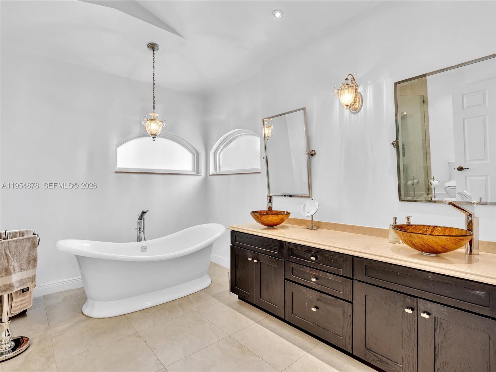 900 Spoonbill Circle Weston, FL 33326 - Photo 26 of 51 a spacious bathroom with a double vanity sink mirror and bathtub