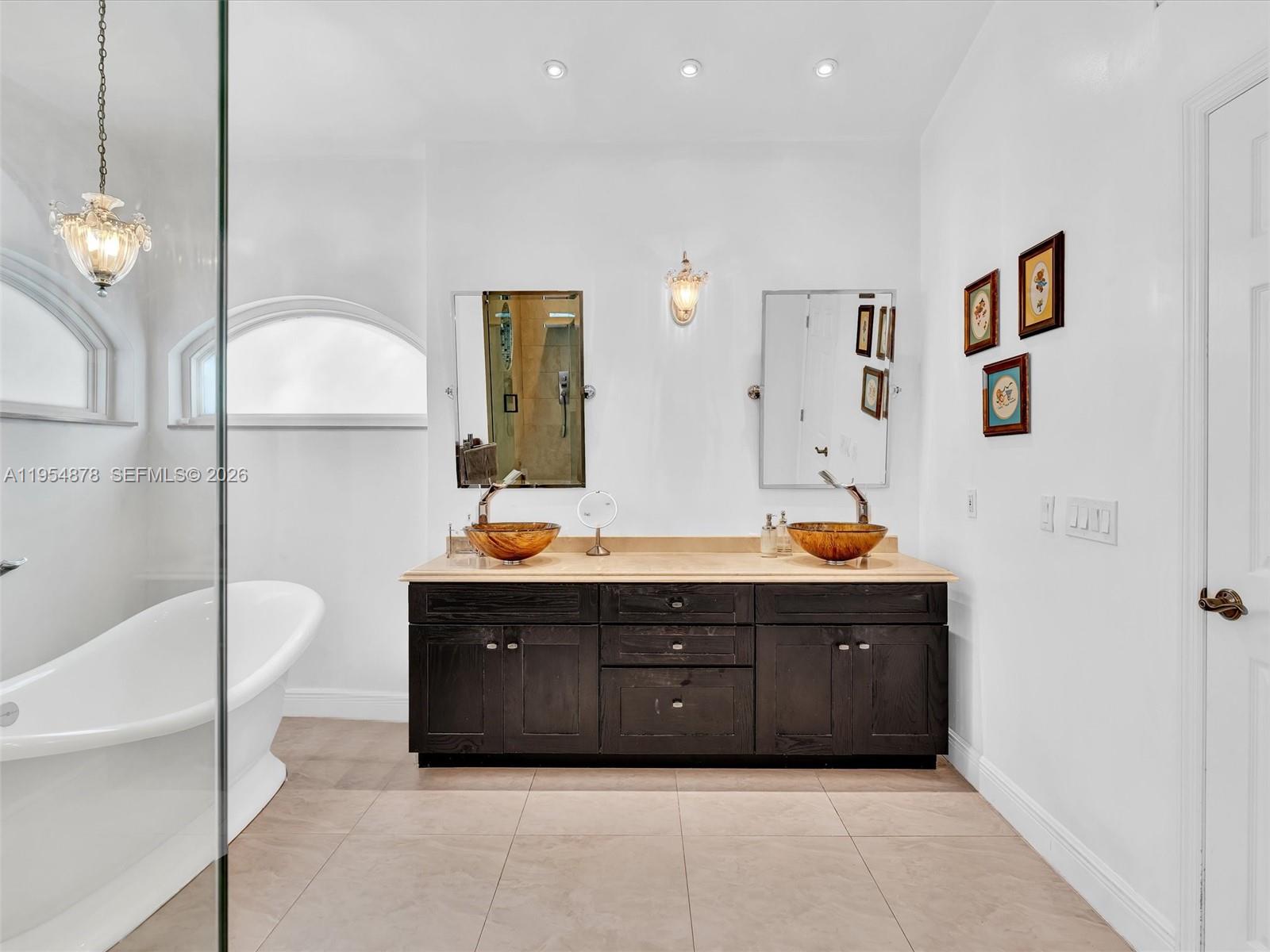 900 Spoonbill Circle Weston, FL 33326 - Photo 29 of 51 a spacious bathroom with a tub double vanity sink and mirror