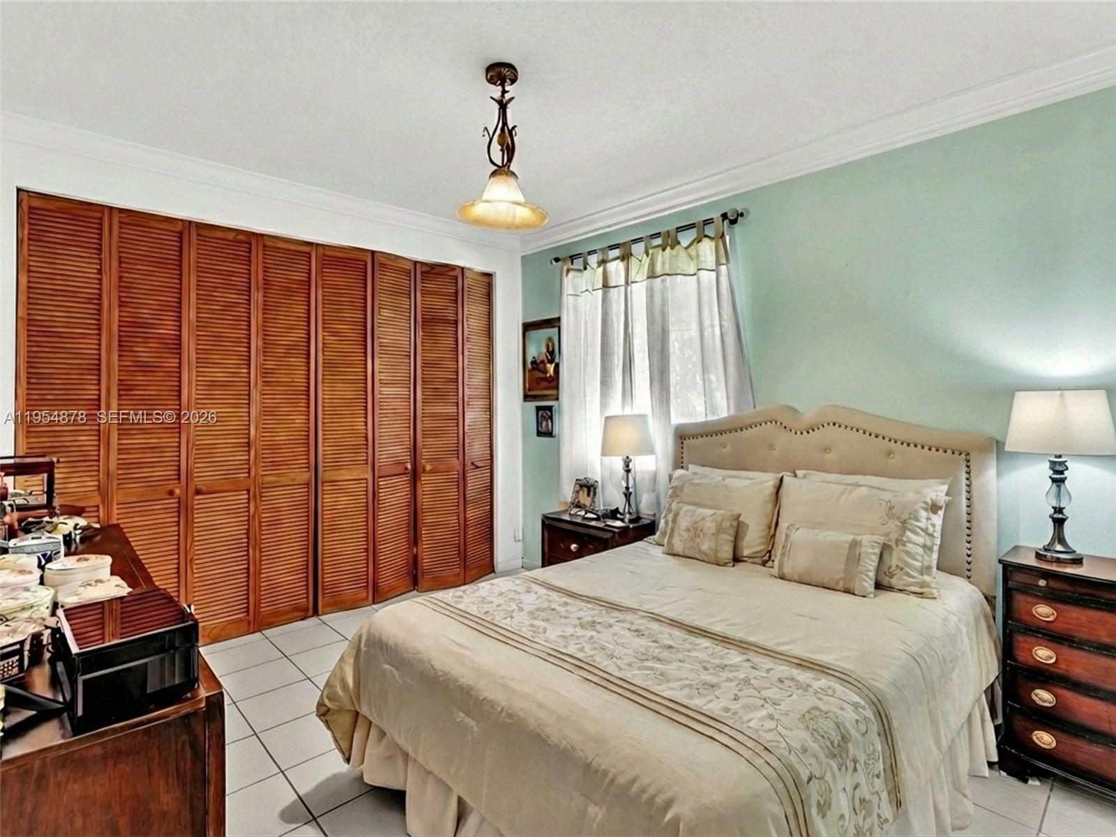 900 Spoonbill Circle Weston, FL 33326 - Photo 30 of 51 a bedroom with a bed and a flat screen tv