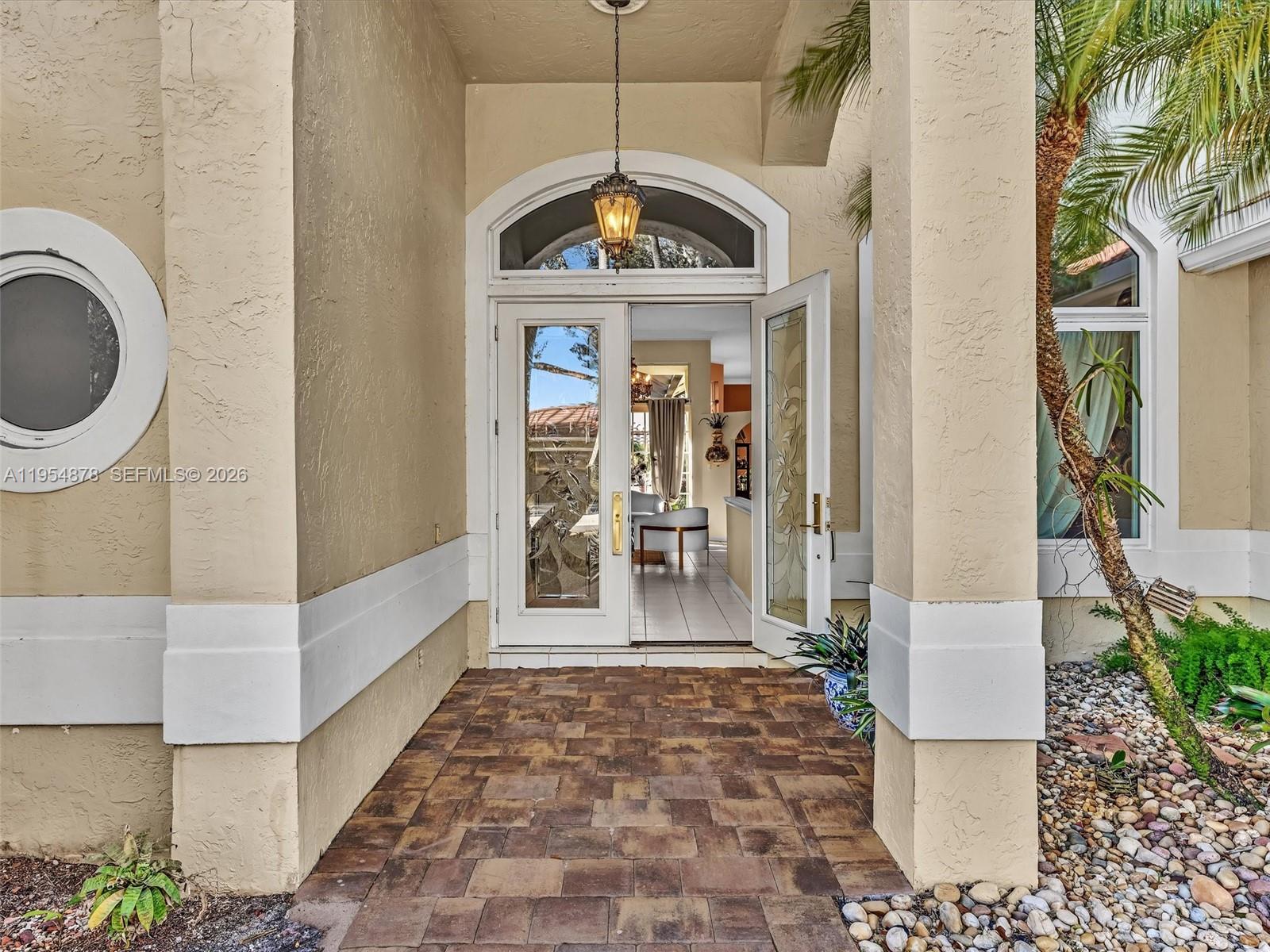 900 Spoonbill Circle Weston, FL 33326 - Photo 3 of 51 a view of a hallway with a chandelier and living room