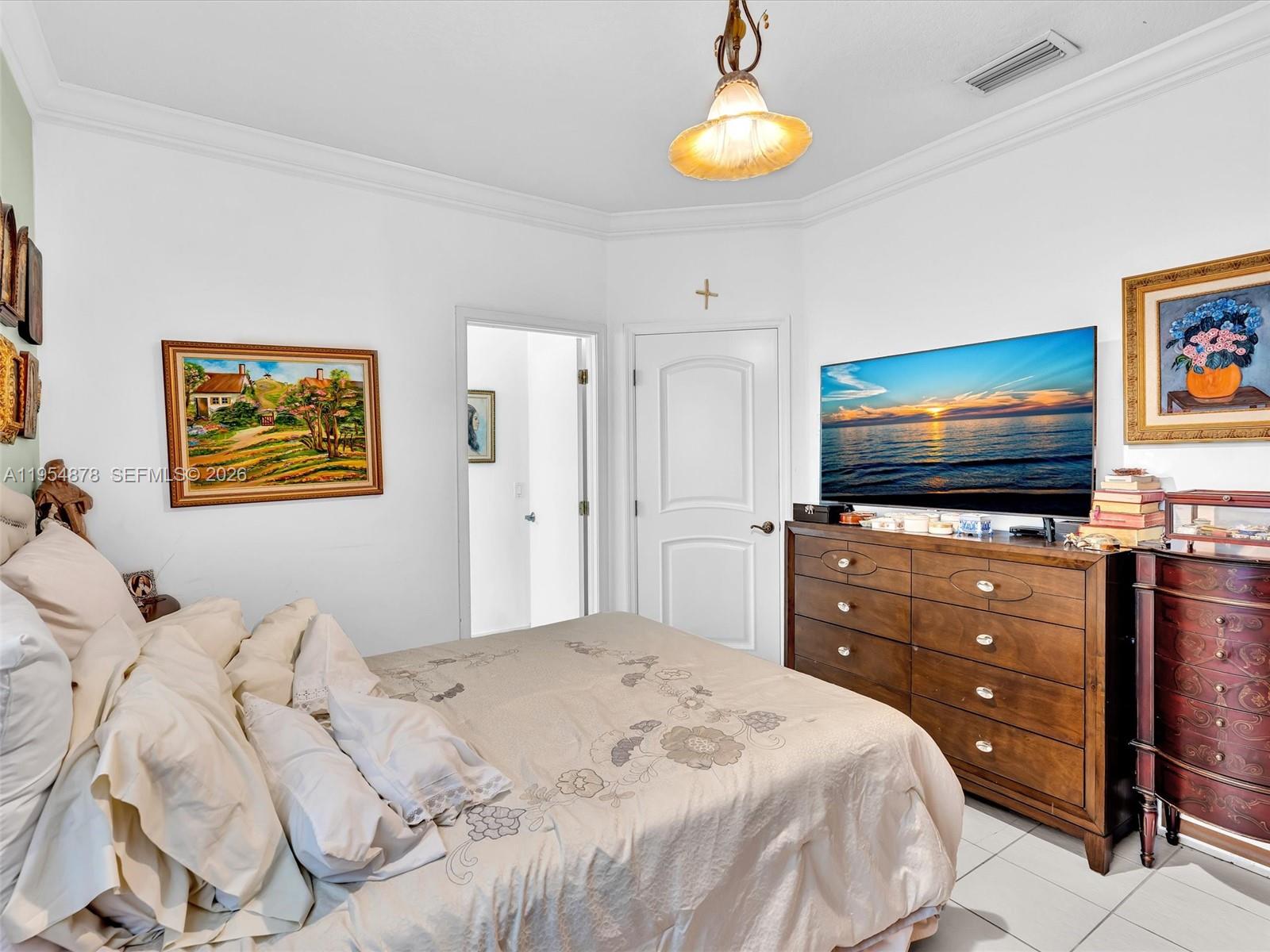 900 Spoonbill Circle Weston, FL 33326 - Photo 31 of 51 a bedroom with a bed and a flat screen tv