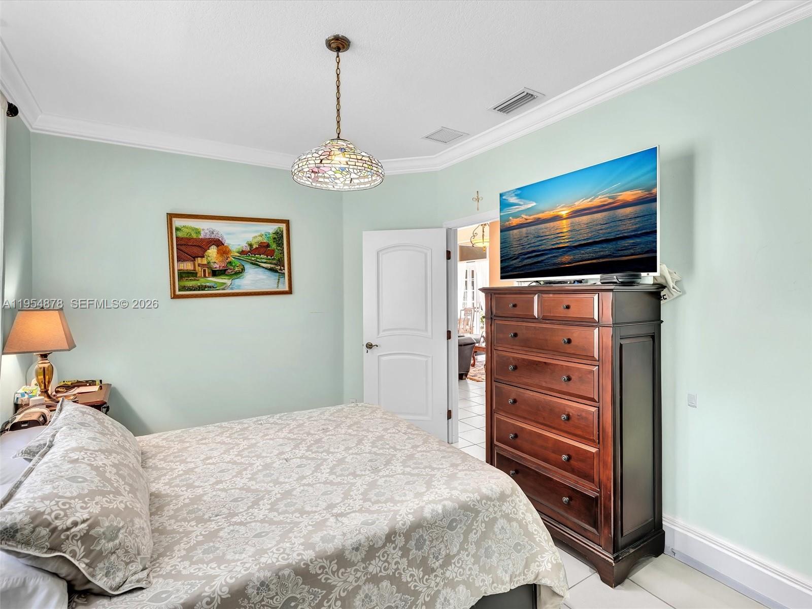 900 Spoonbill Circle Weston, FL 33326 - Photo 35 of 51 a bedroom with a bed and a flat screen tv