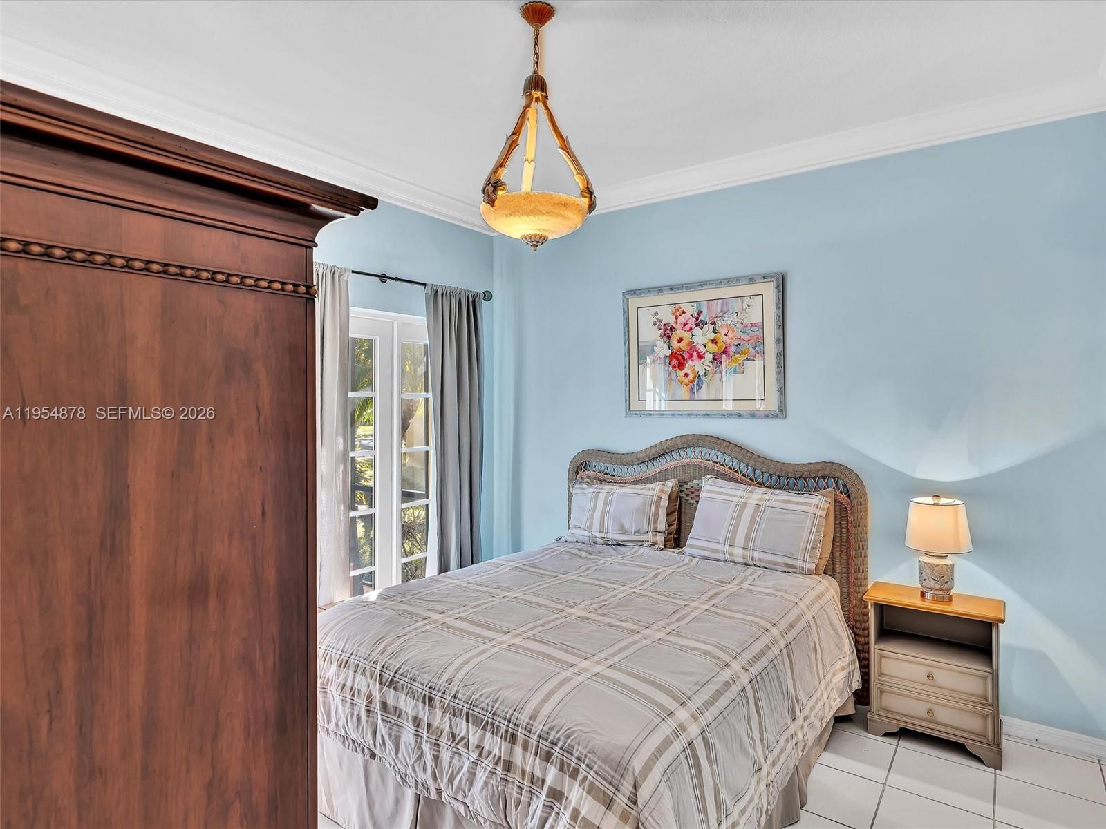 900 Spoonbill Circle Weston, FL 33326 - Photo 36 of 51 a bedroom with a bed and a lamp on dresser