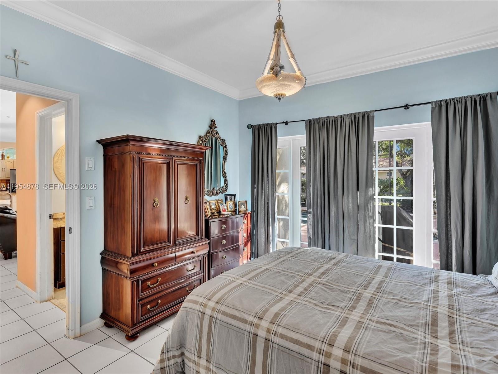 900 Spoonbill Circle Weston, FL 33326 - Photo 37 of 51 a bedroom with a bed and wooden floor