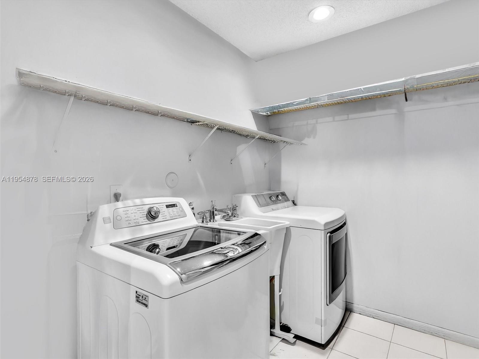 900 Spoonbill Circle Weston, FL 33326 - Photo 40 of 51 a utility room with washer and dryer