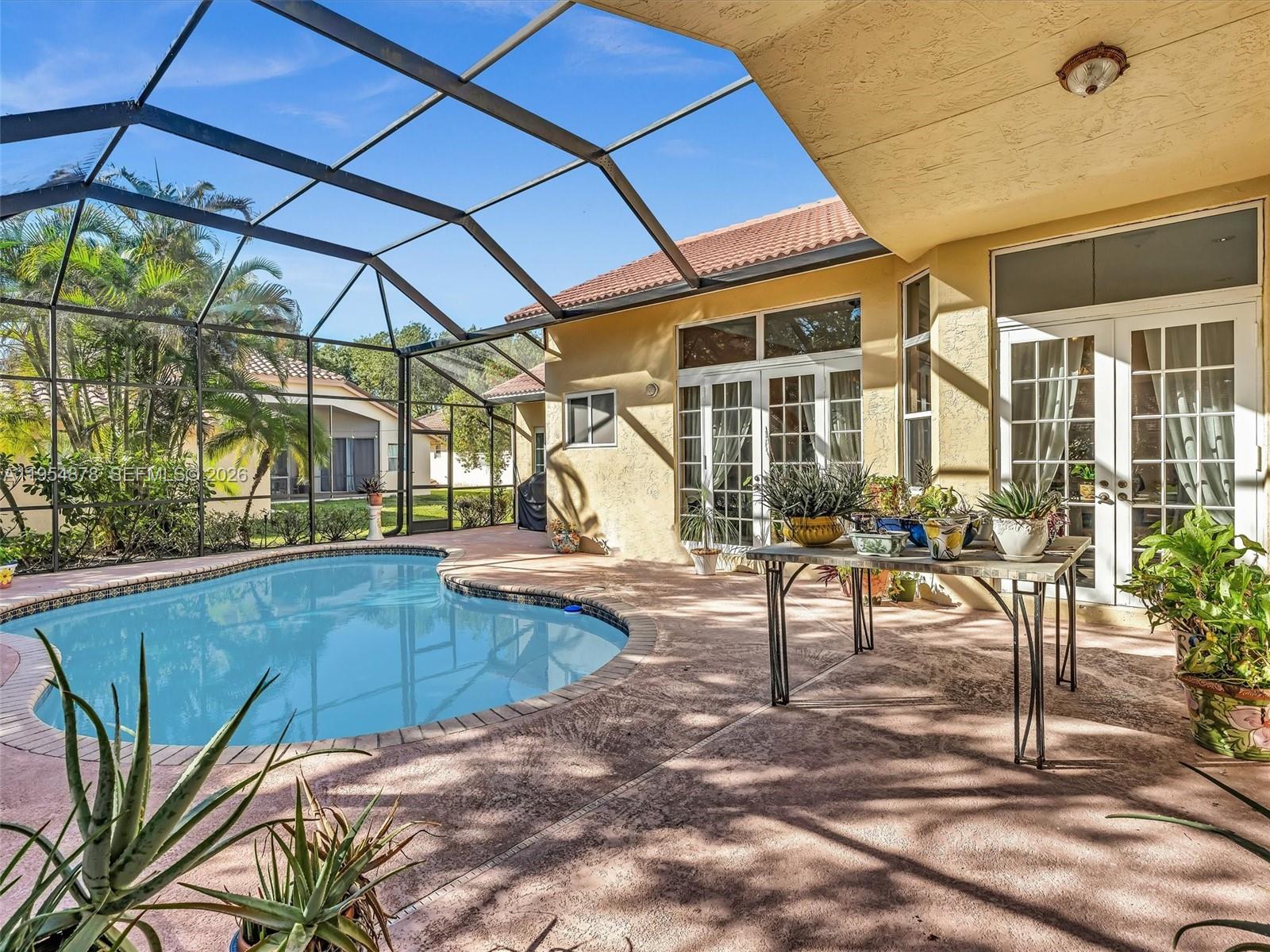 900 Spoonbill Circle Weston, FL 33326 - Photo 43 of 51 a view of a swimming pool with a patio