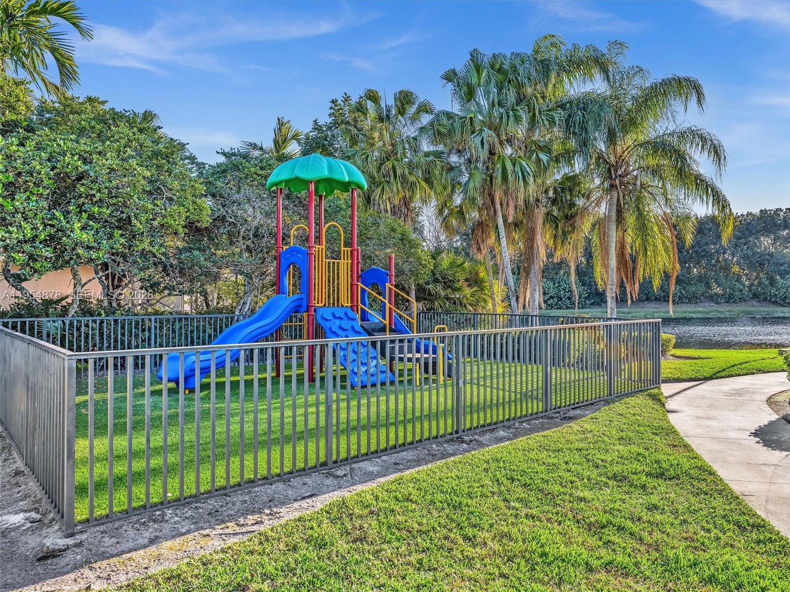 900 Spoonbill Circle Weston, FL 33326 - Photo 48 of 51 a view of a swimming pool with a garden and trees