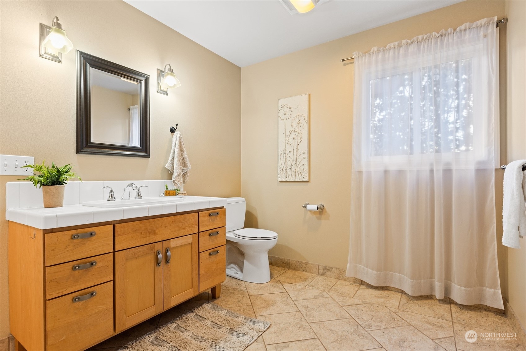 131 Hawthorn Road Bellingham, WA 98225 - Photo 33 of 40 a bathroom with a double vanity sink a toilet and a mirror