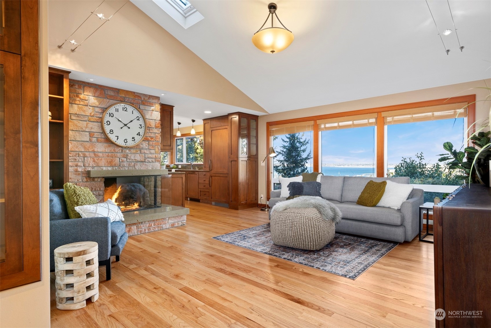 131 Hawthorn Road Bellingham, WA 98225 - Photo 6 of 40 a living room with furniture a fireplace and a floor to ceiling window