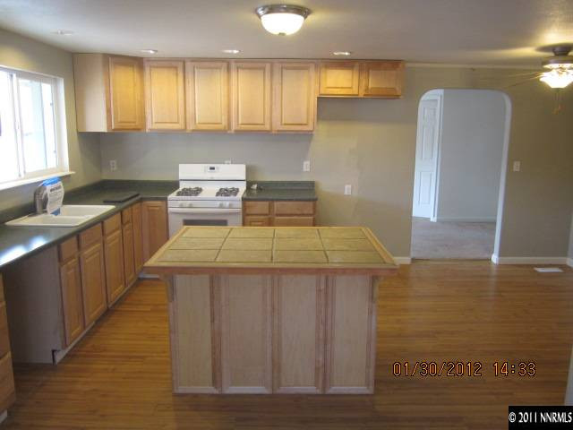 9375 Fremont Way Reno, NV 89506 - Photo 5 of 12 a kitchen with a stove a sink and a refrigerator