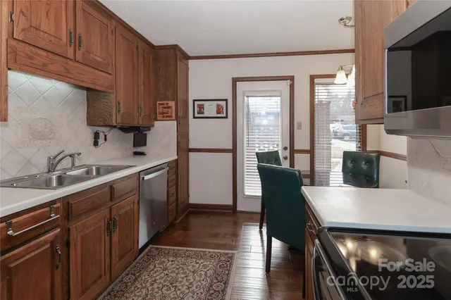a kitchen with a table chairs sink and cabinets