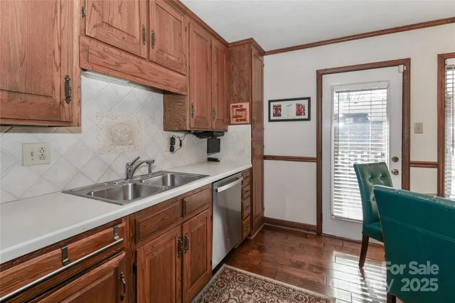 a kitchen with a sink a refrigerator and cabinets