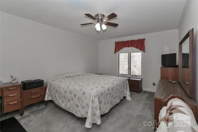 a spacious bedroom with a bed and window