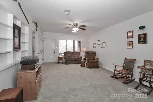 a living room with furniture and a gym machine
