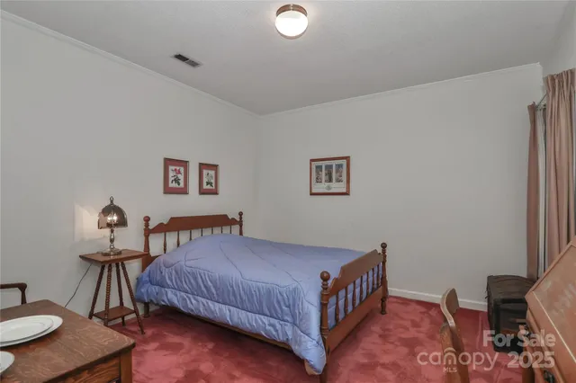 a bedroom with a bed and a table in it