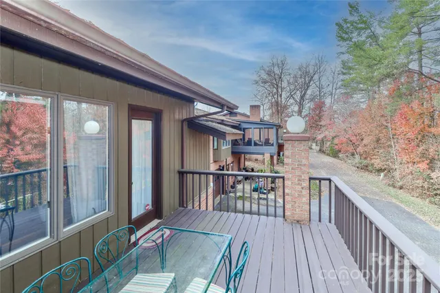 a balcony with furniture and wooden floor