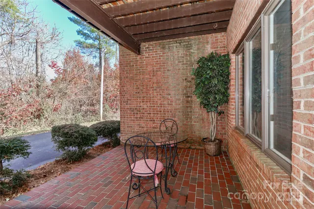 a view of a balcony with table and chairs and wooden floor