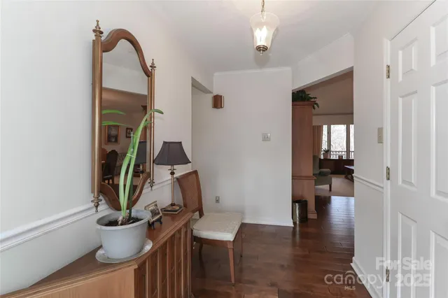 a view of entryway and hall with wooden floor