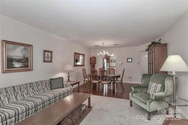 a living room with furniture a lamp dining table and a lamp