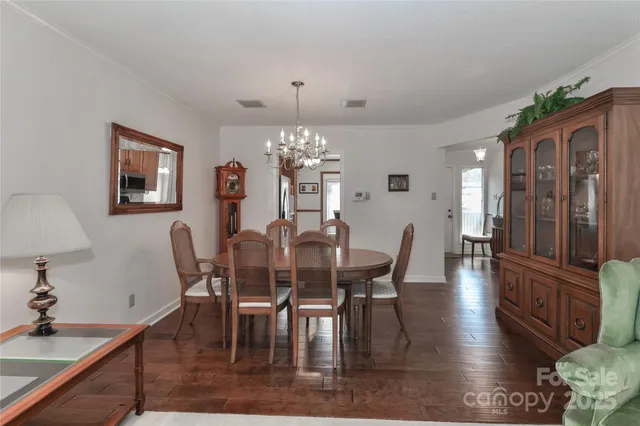 a view of a dining room with furniture and chandelier