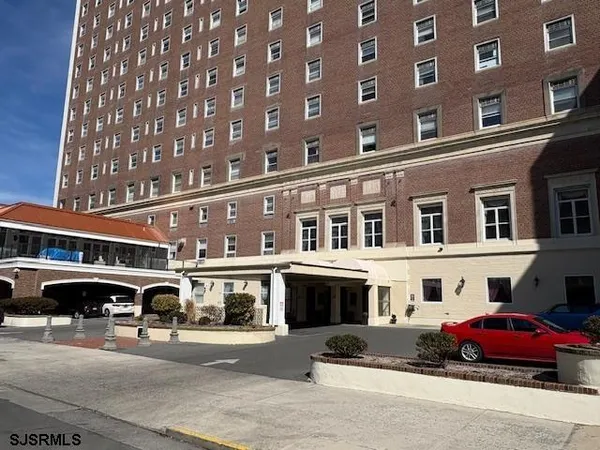 a front view of a building with parking space