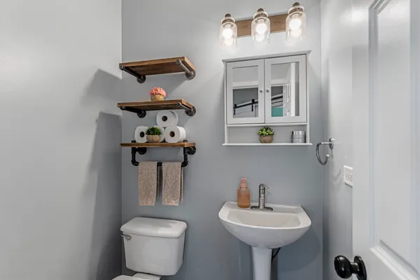a bathroom with a sink a mirror and a toilet